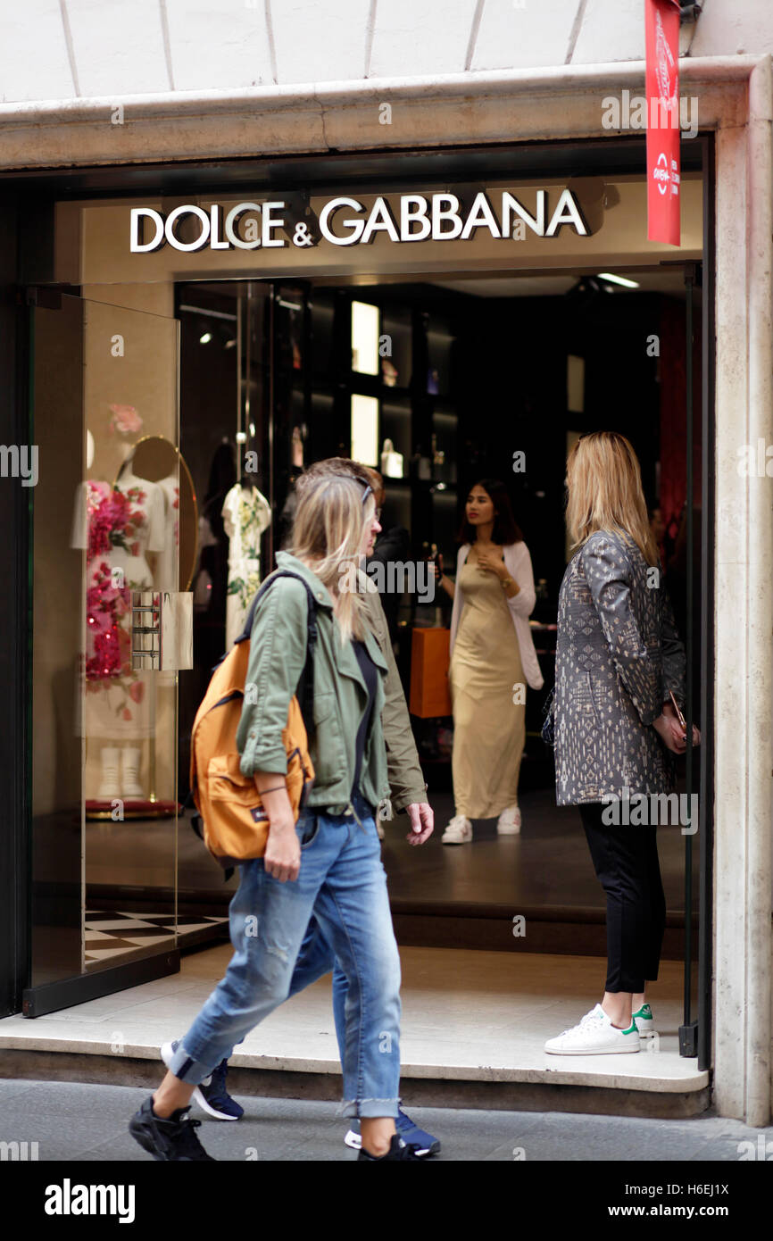 Pedestrian walks in front of the Dolce&Gabbana store on Via del Corso