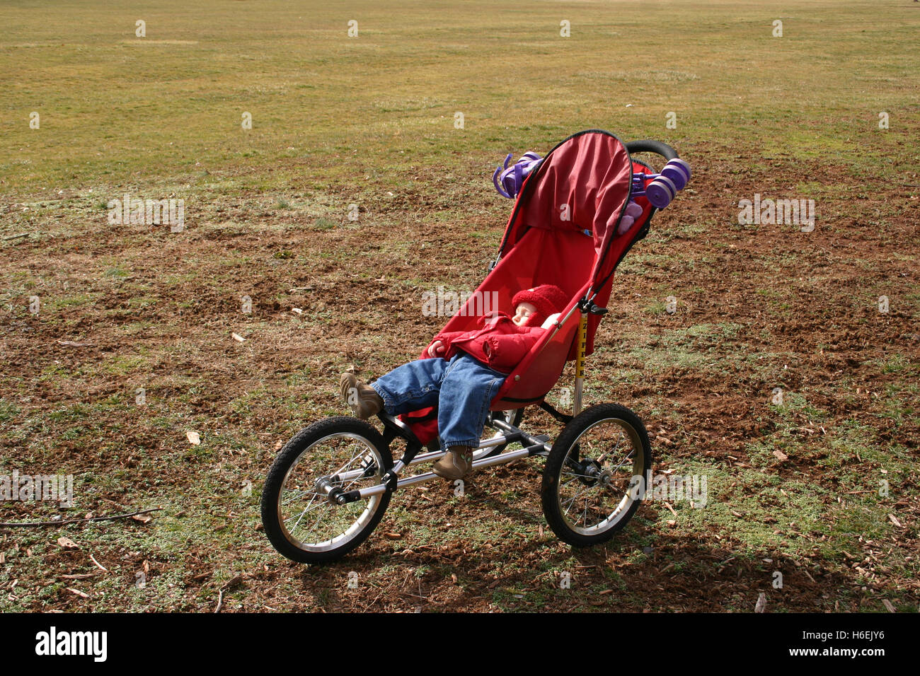 Baby girl sleeping in stroller outside, in a cold day Stock Photo Alamy