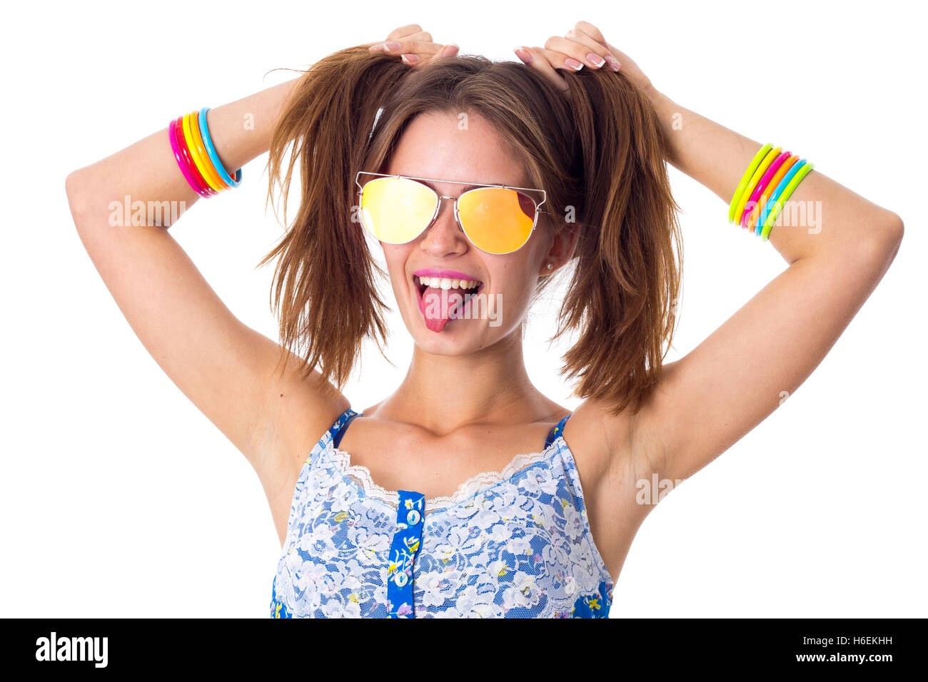 Woman in sunglasses making ponytails and showing tongue Stock Photo
