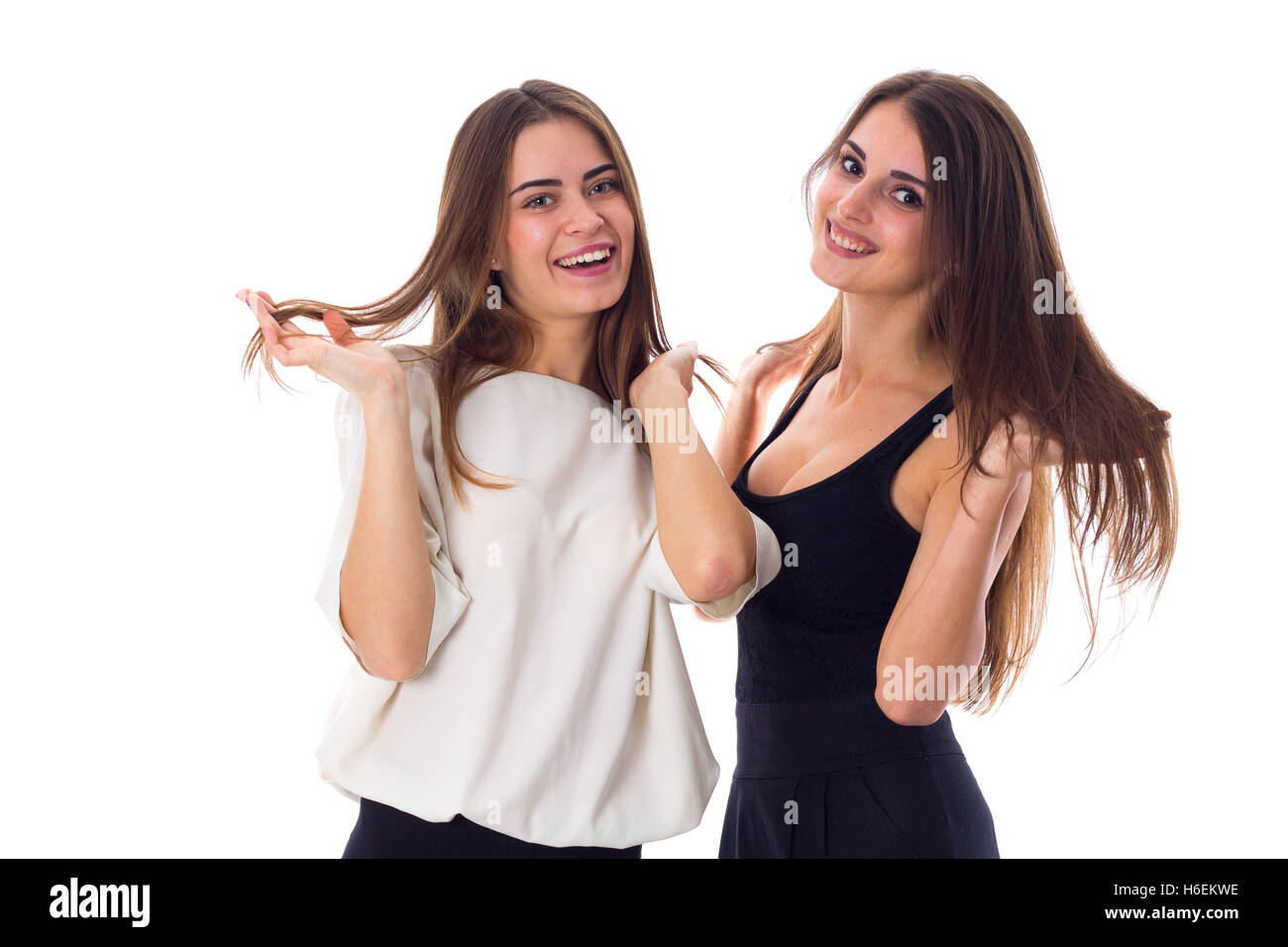 Two young woman touching hair Stock Photo Alamy