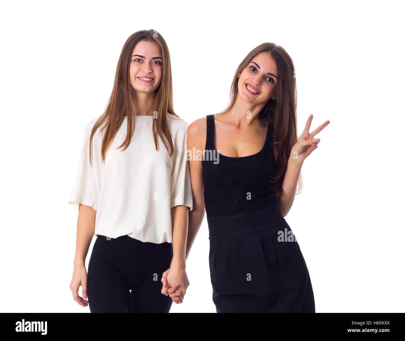 Two young woman holding hands Stock Photo