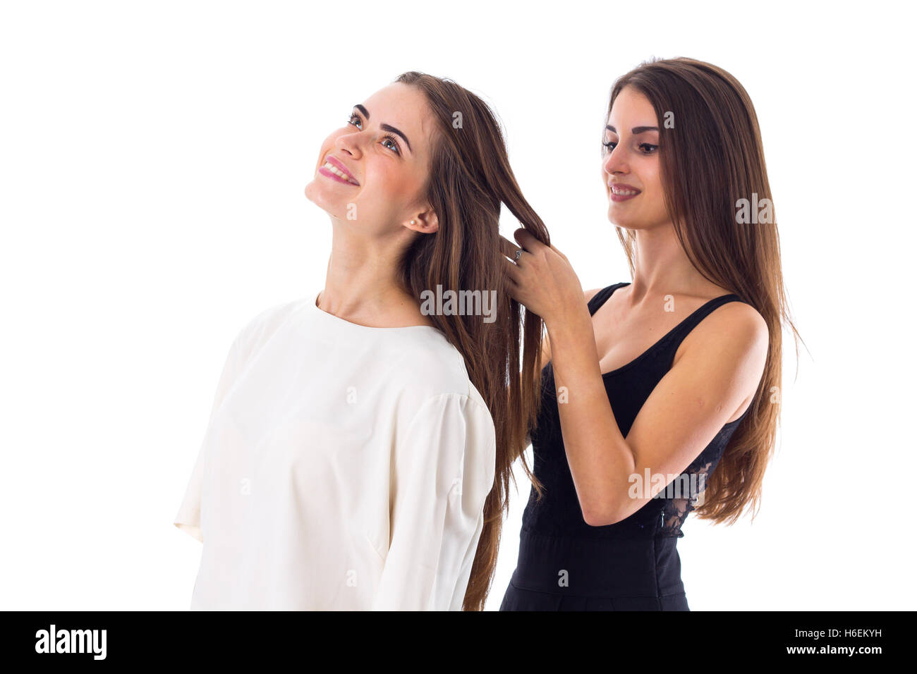 One woman making another one a plait Stock Photo