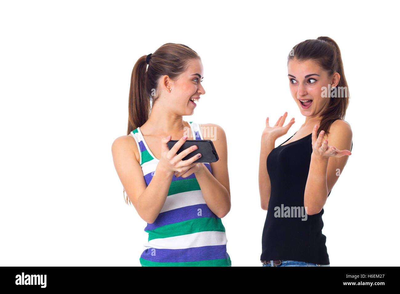 Two young women using smartphone Stock Photo
