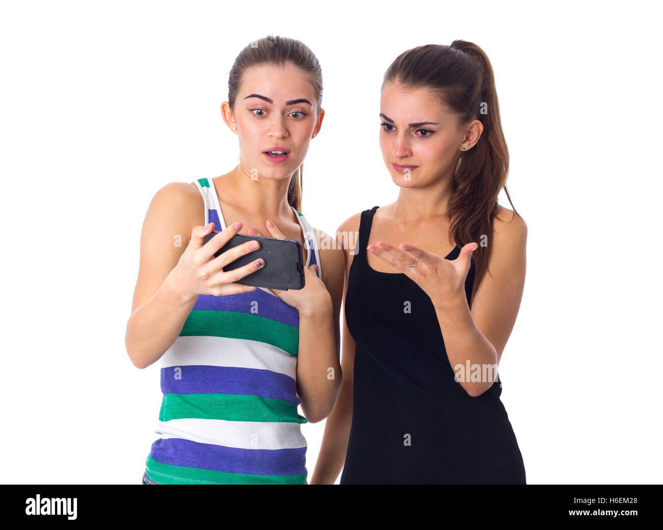 Two young women using smartphone Stock Photo - Alamy