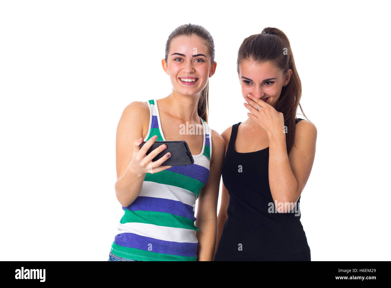 Two young women using smartphone Stock Photo - Alamy