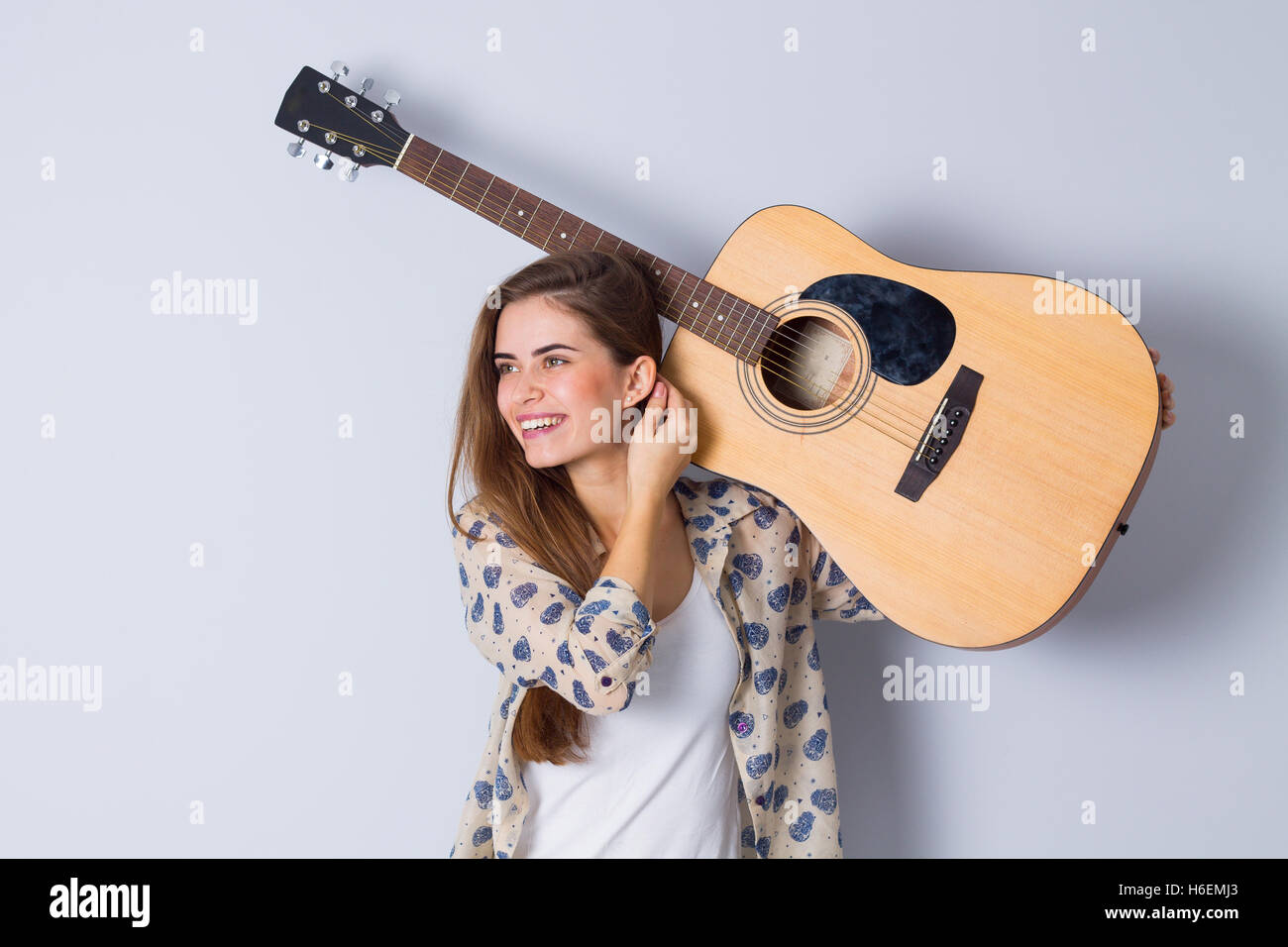 Young woman holding a guitar Stock Photo - Alamy