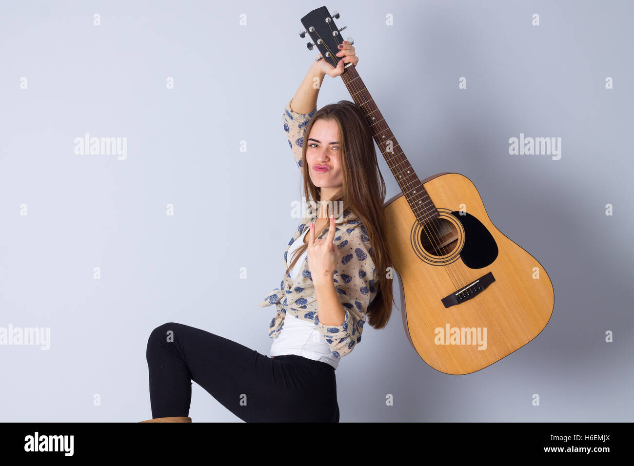 Young woman holding a guitar Stock Photo - Alamy