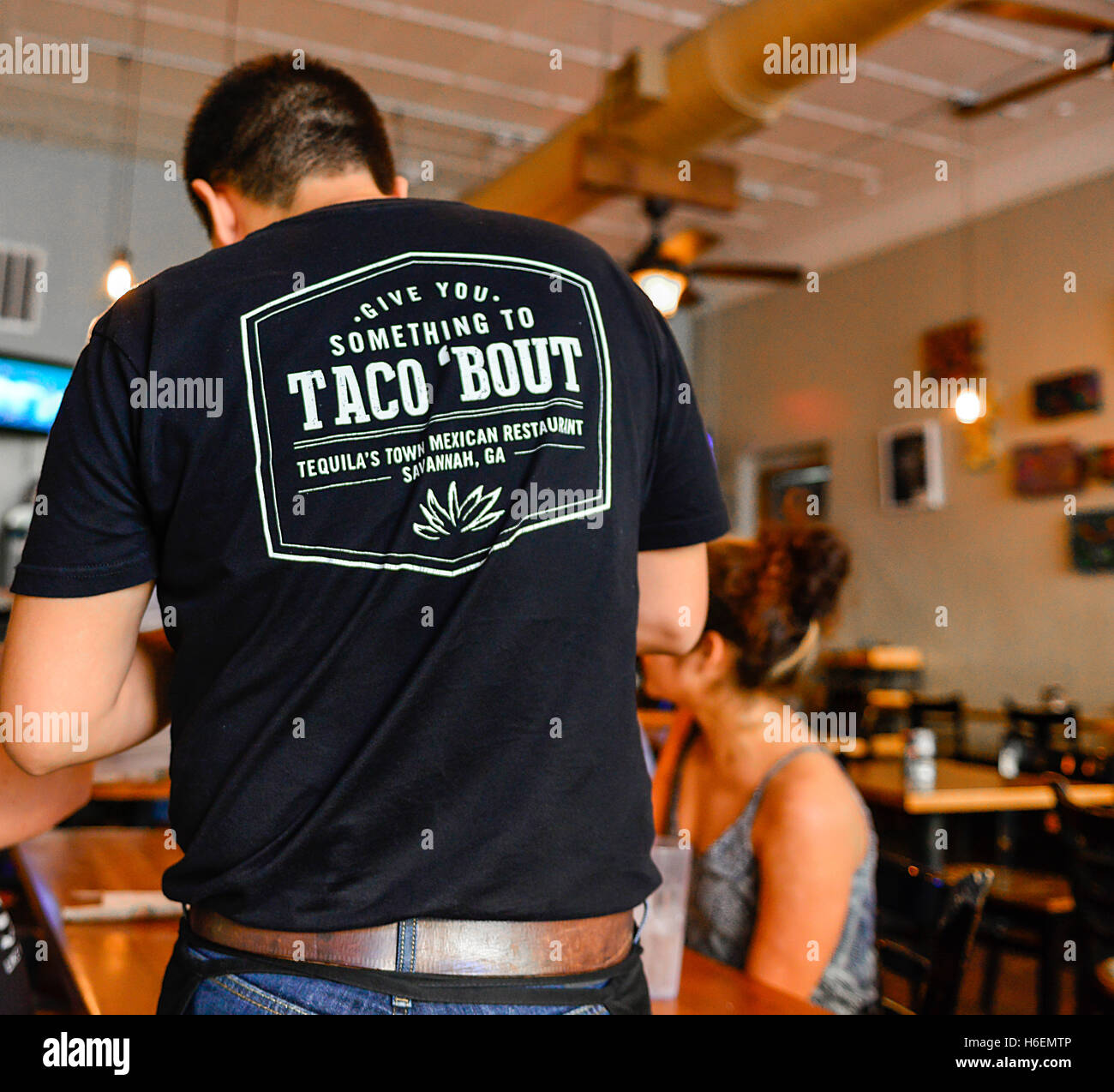 Waiter's tee shirt branding Slogan reads 'Give you something to Taco 'bout' Tequila's Town Mexican Restaurant in Savannah, GA Stock Photo