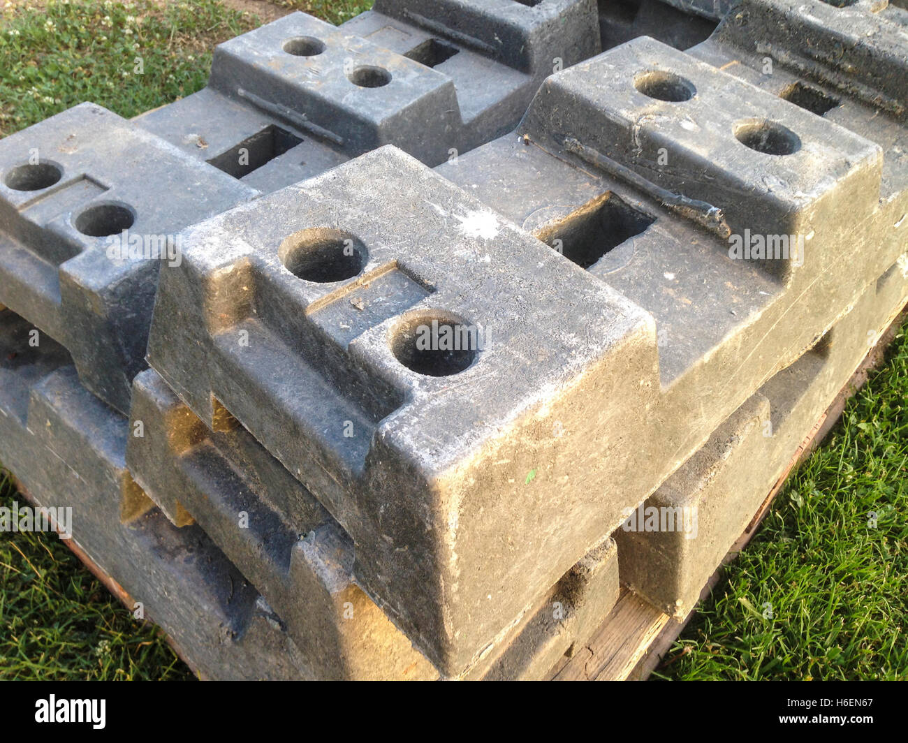 Concrete temporary fence feet stacked for next event Stock Photo
