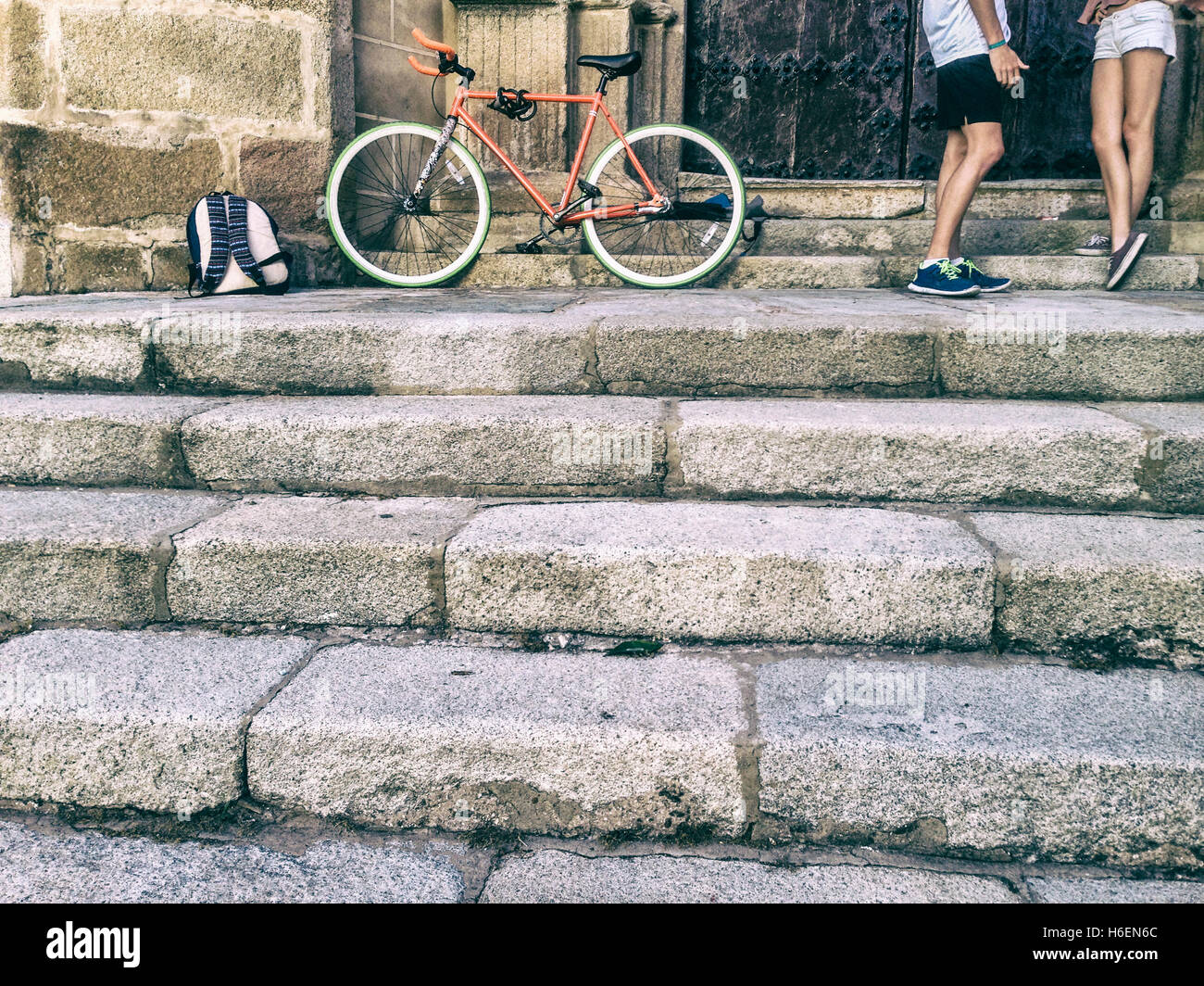 Young couple friendship with a fixed gear bicycle parked at old town Stock Photo