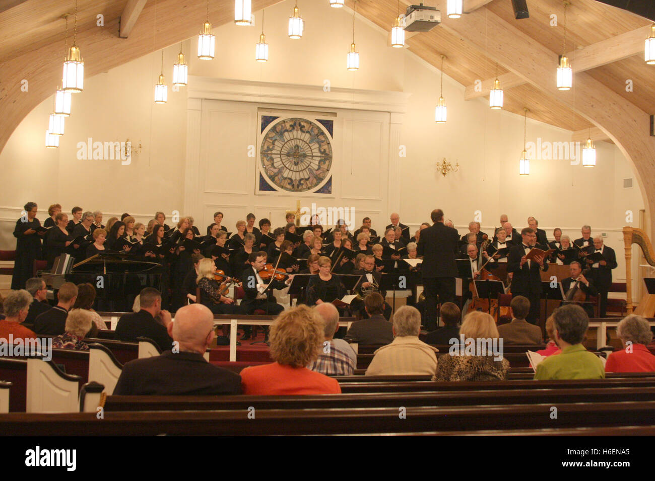 Choir and orchestra having a public performance in church Stock Photo