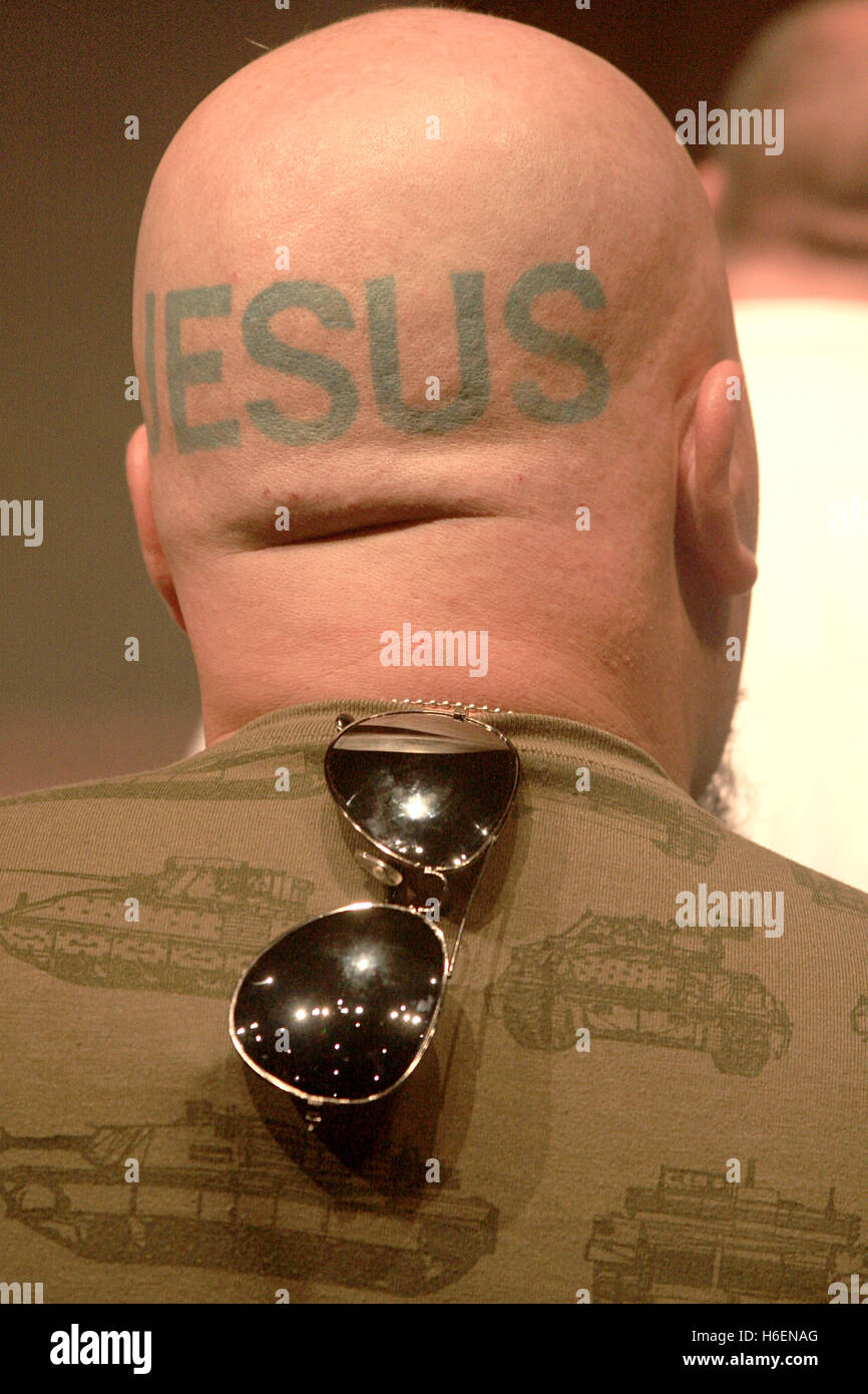 The word JESUS tattooed on man's back of the head Stock Photo