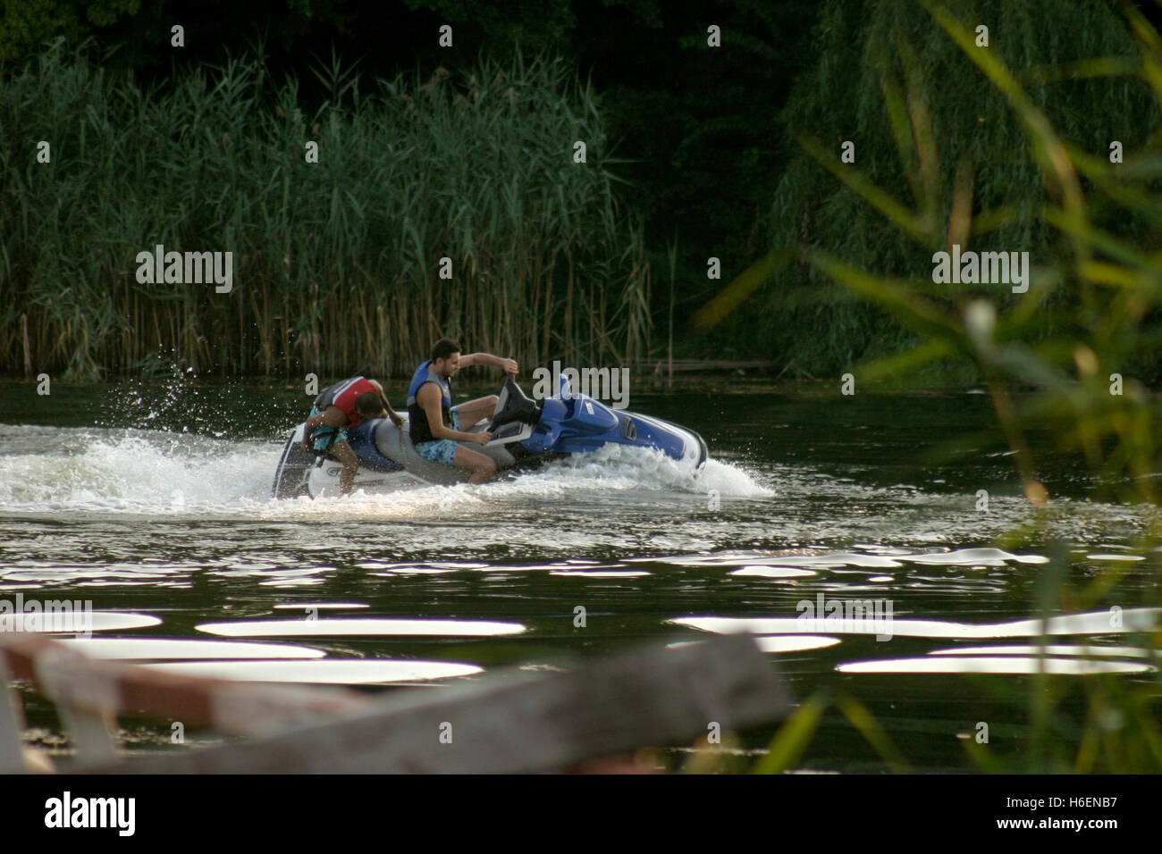 People riding water scooter (jetski) on lake Stock Photo Alamy