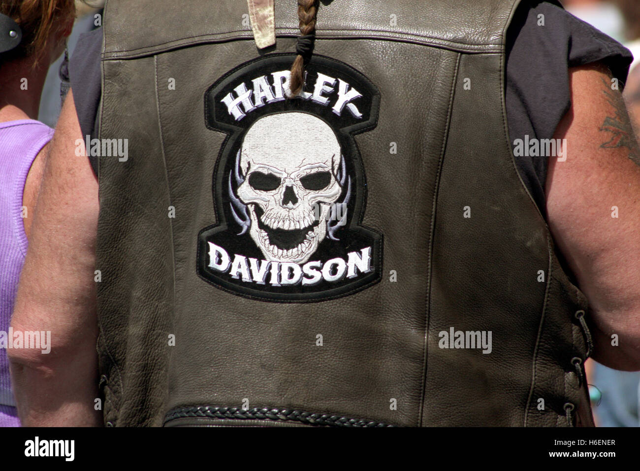 Skull design on back of Harley Davidson motorcycle vest worn by man Stock Photo
