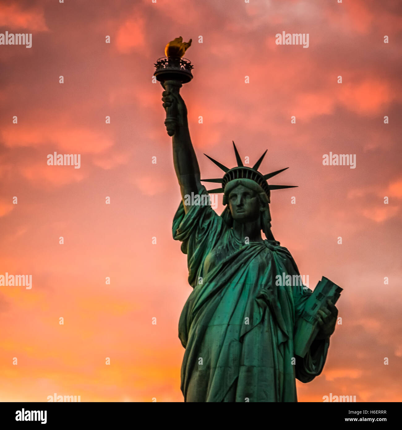 Statue of Liberty was taken at sunset. The sunset colors were vibrant and the clouds were perfect contrasting with green statue Stock Photo