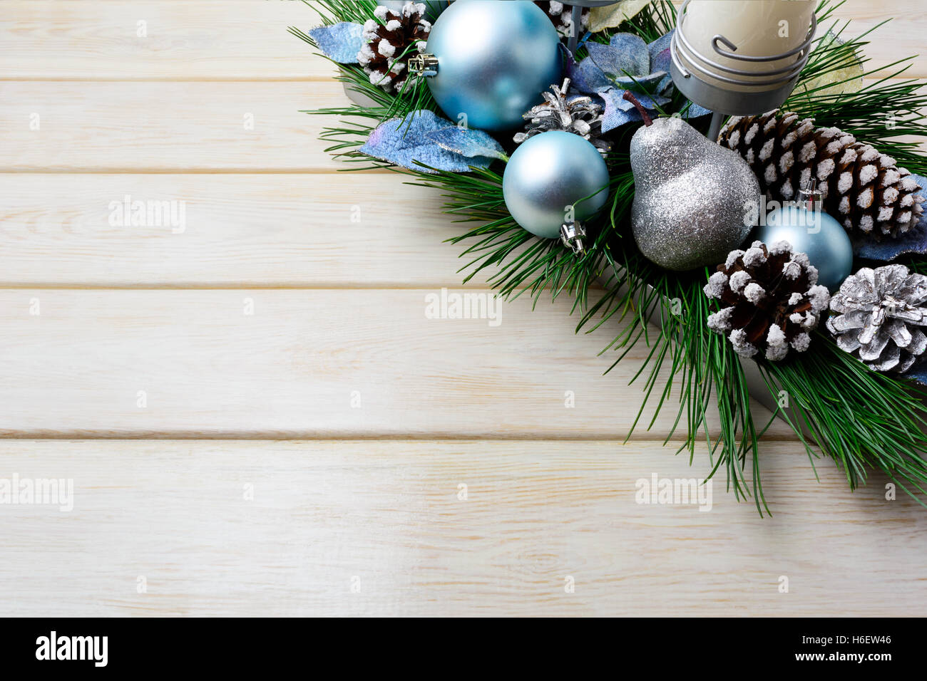 Christmas background with holiday decorated candleholder and blue ornaments. Christmas decoration with pine cones. Christmas gre Stock Photo