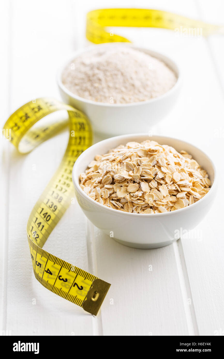 The diet concept. Oatmeal and measuring tape. Stock Photo