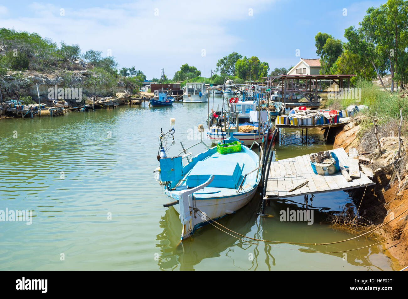 The small fishing village is full of old wooden boats, moored next to the river banks, Liopetri, Cyprus. Stock Photo
