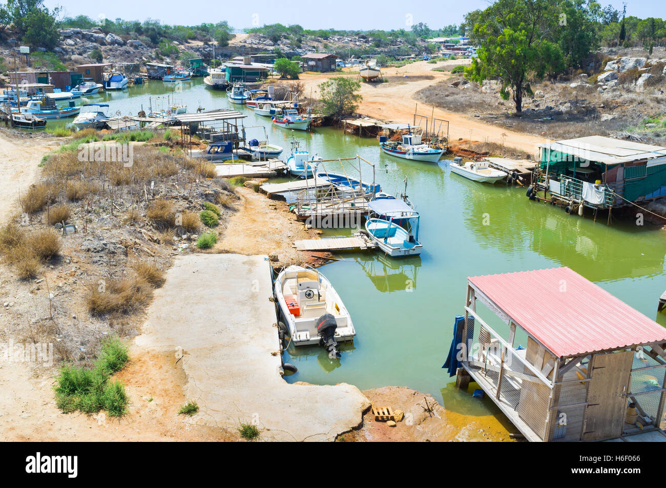 Many fishing boats moored on the banks of the narrow winding riverbed, Liopetri, Cyprus. Stock Photo