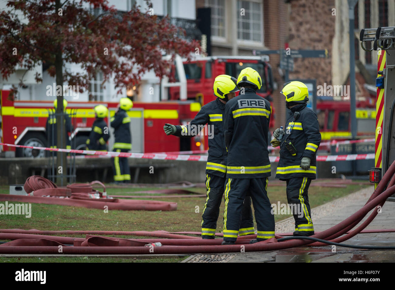 Firefighters on Exeter's Cathedral Green, UK, following a blaze in the Castle Art Gallery. Stock Photo