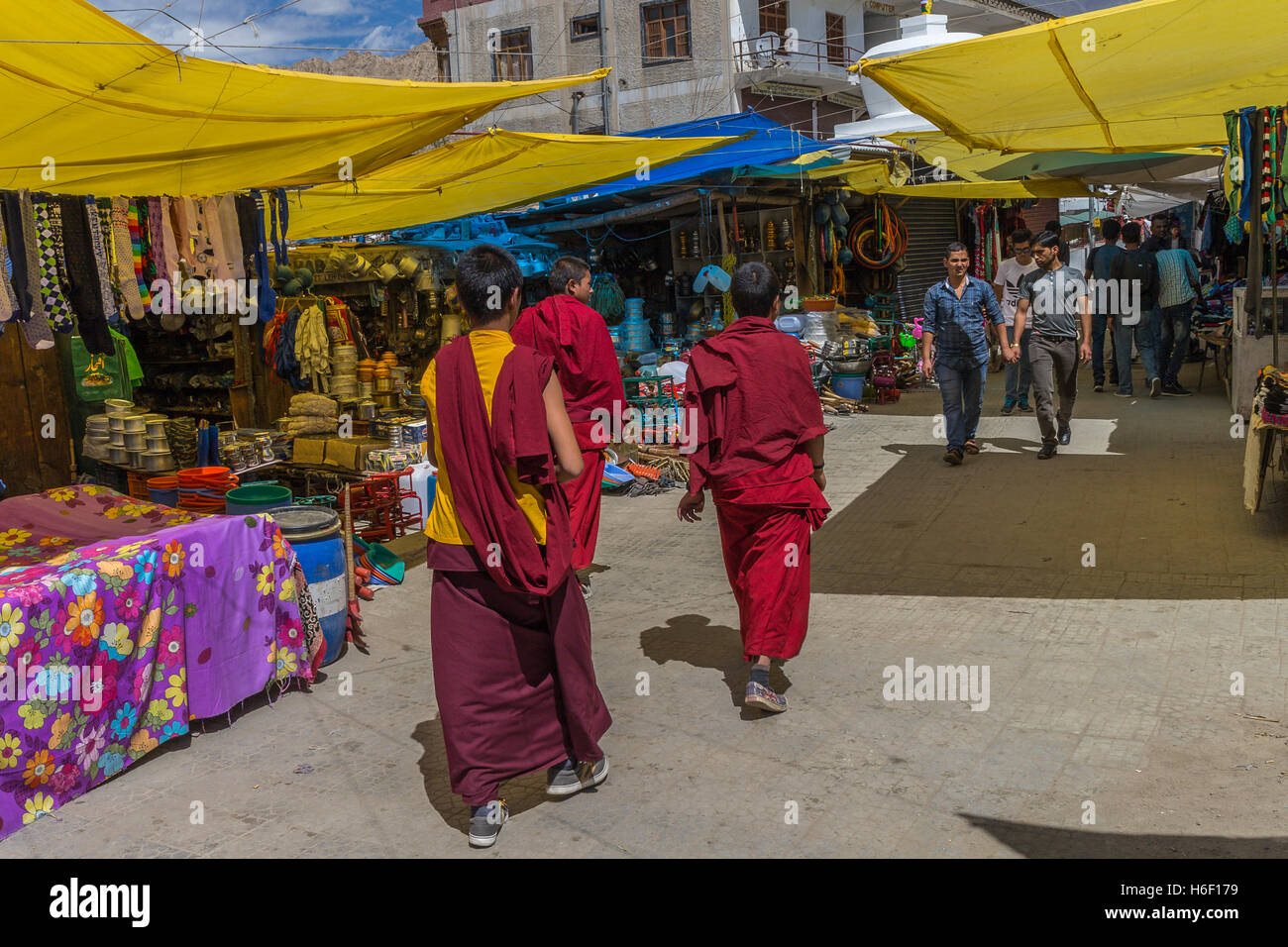 Three monks walking through Leh Market Stock Photo
