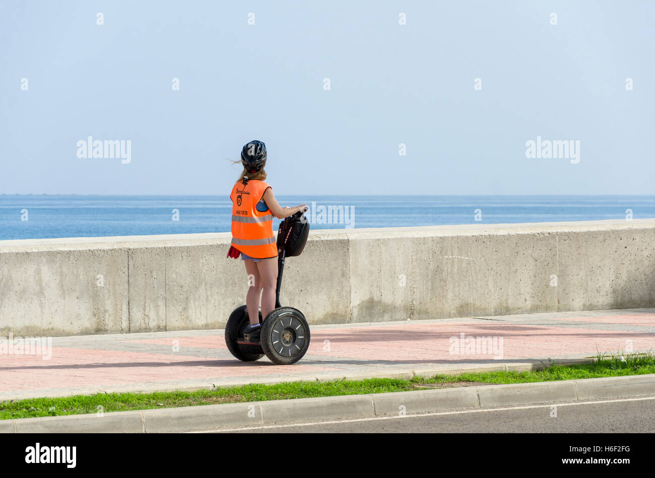 Young tourist visiting Malaga with segway at sea promenade, mediterranean, Port of Malaga, Spain. Stock Photo