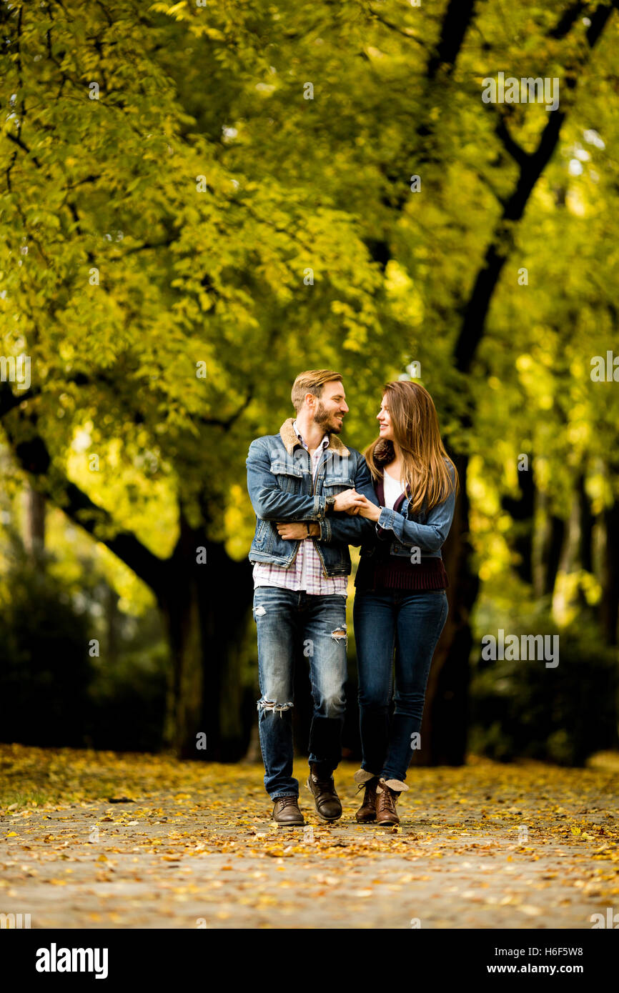 Young loving couple having a walk in the autumn park Stock Photo - Alamy