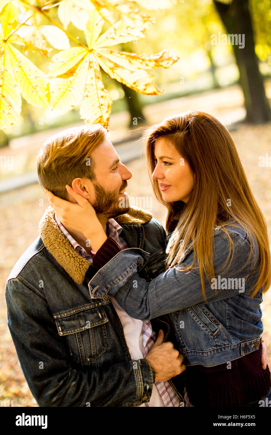Loving couple exchanging tenderness in the autumn park Stock Photo