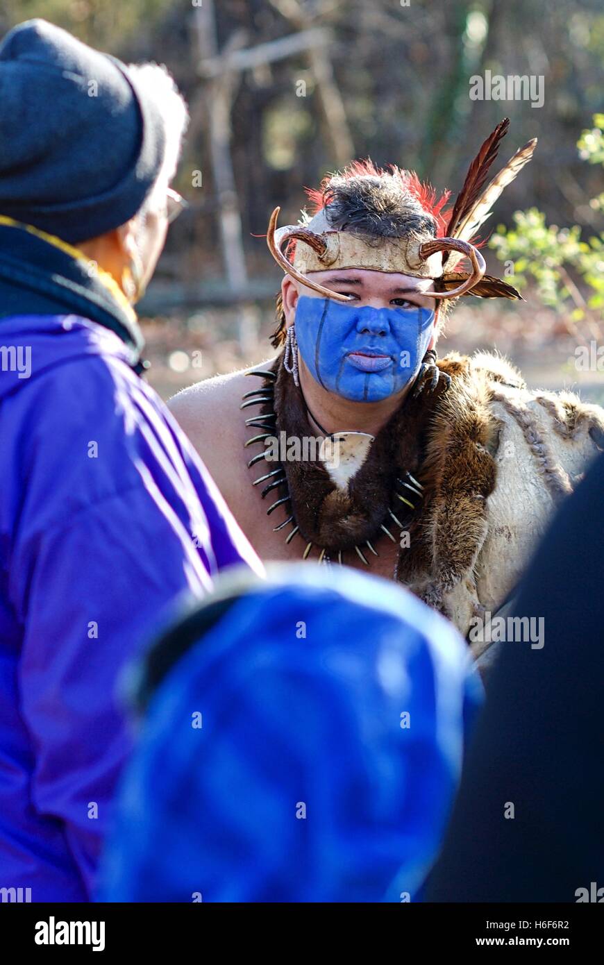 A Native American interpreter educates tourists at the Jamestowne Settlement adjacent to the actual Jamestown historic site. Stock Photo