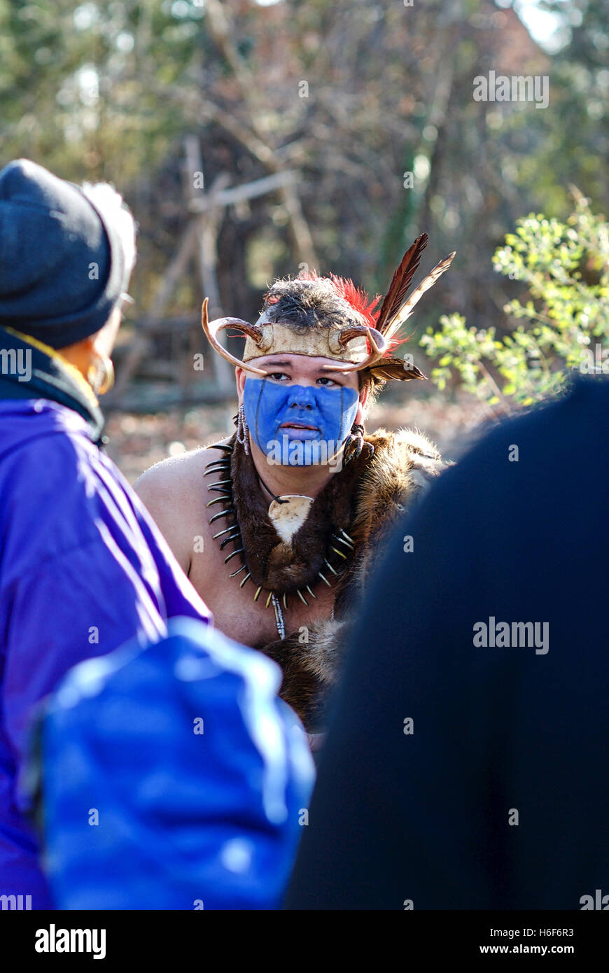 A Native American interpreter educates tourists at the Jamestowne Settlement adjacent to the actual Jamestown historic site. Stock Photo