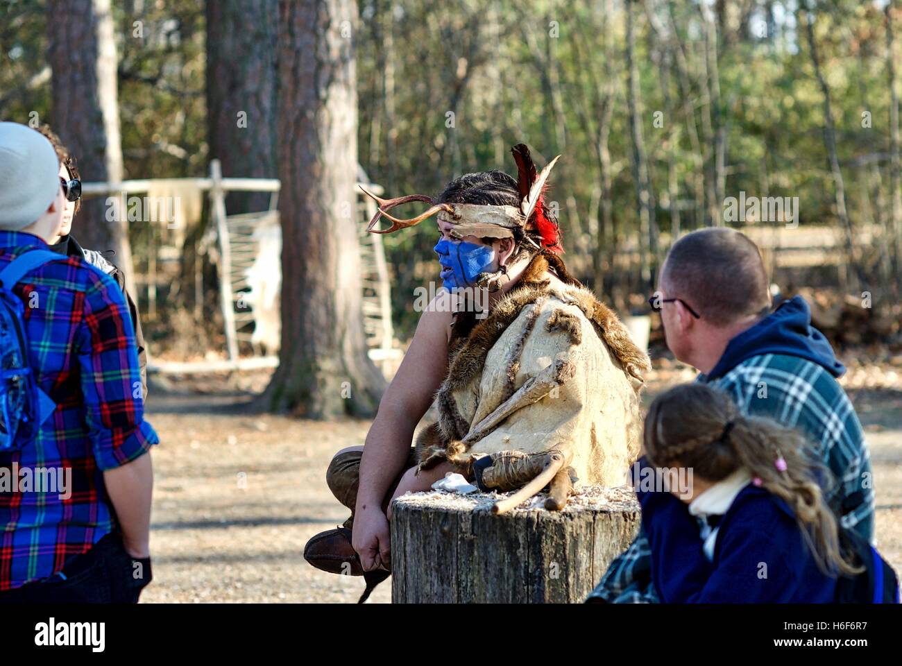 A Native American interpreter educates tourists at the Jamestowne Settlement adjacent to the actual Jamestown historic site. Stock Photo