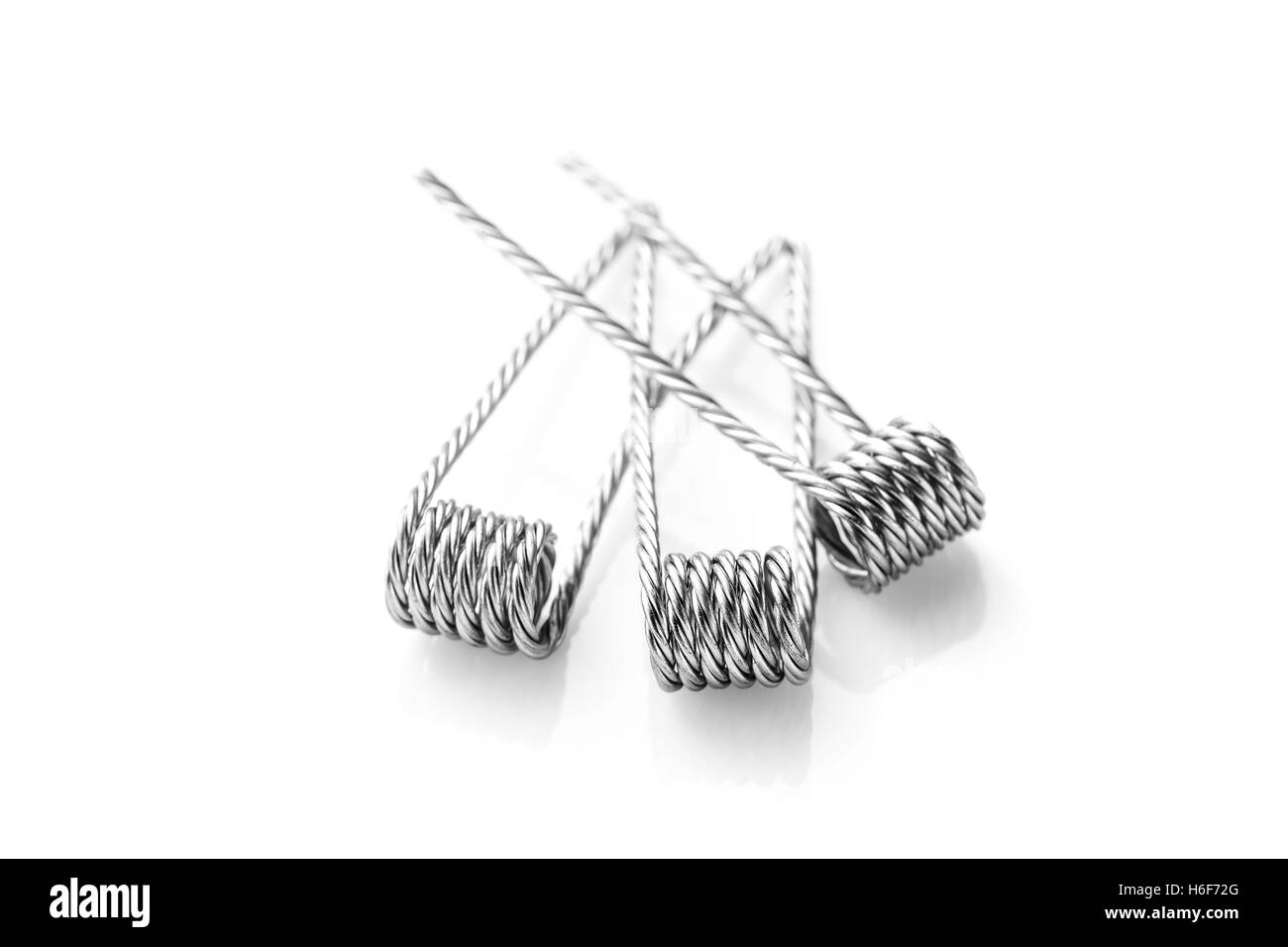 Quad coils for vaping on a white background macro closeup wire steel