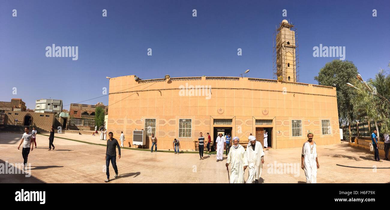 BECHAR, ALGERIA - OCTOBER 27, 2016: Madjid Essalam mosque in Bechar. People moving out from the Friday pray. Mosque is being ren Stock Photo
