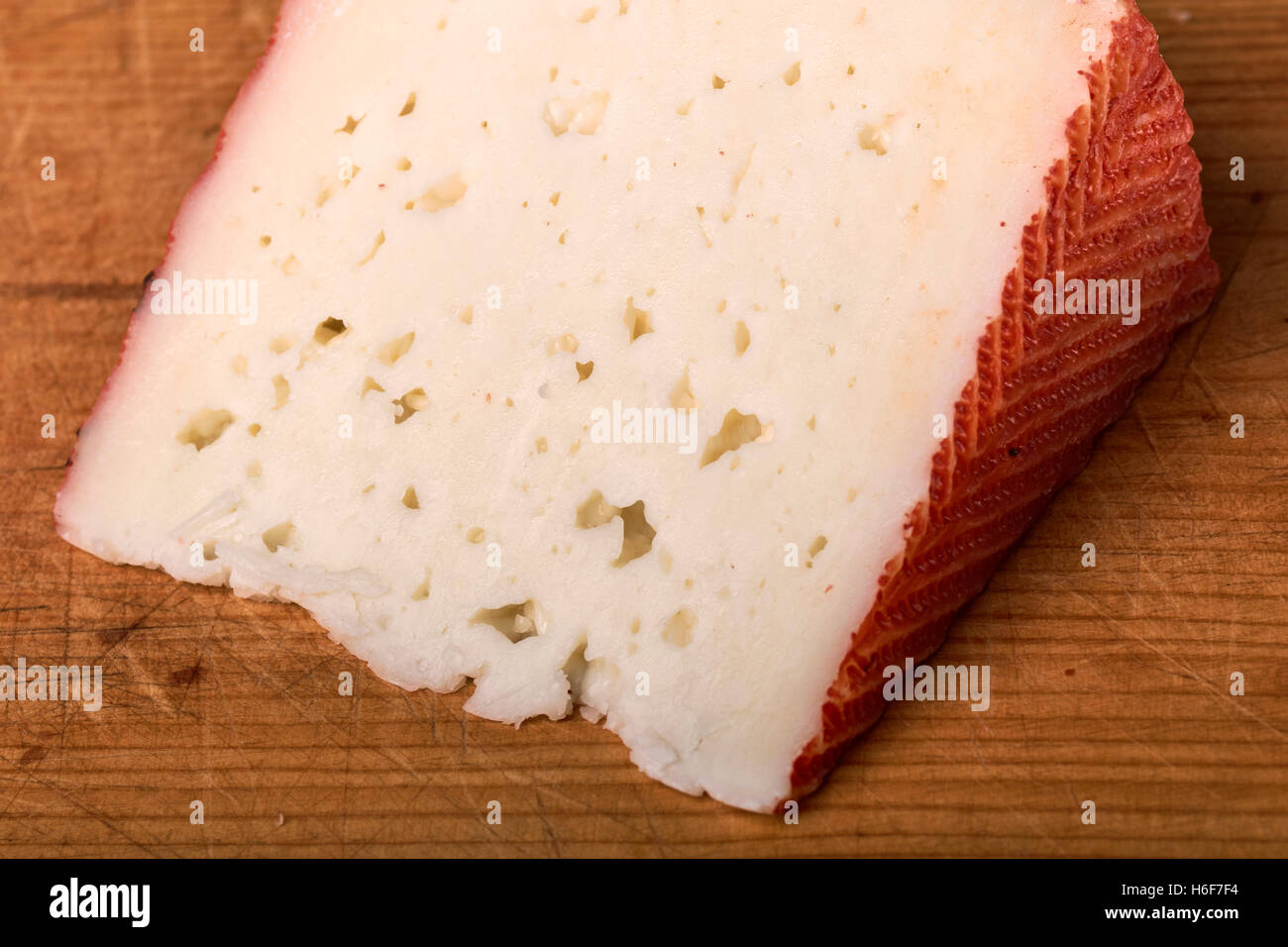 Goat cheese wedge. Stock Photo