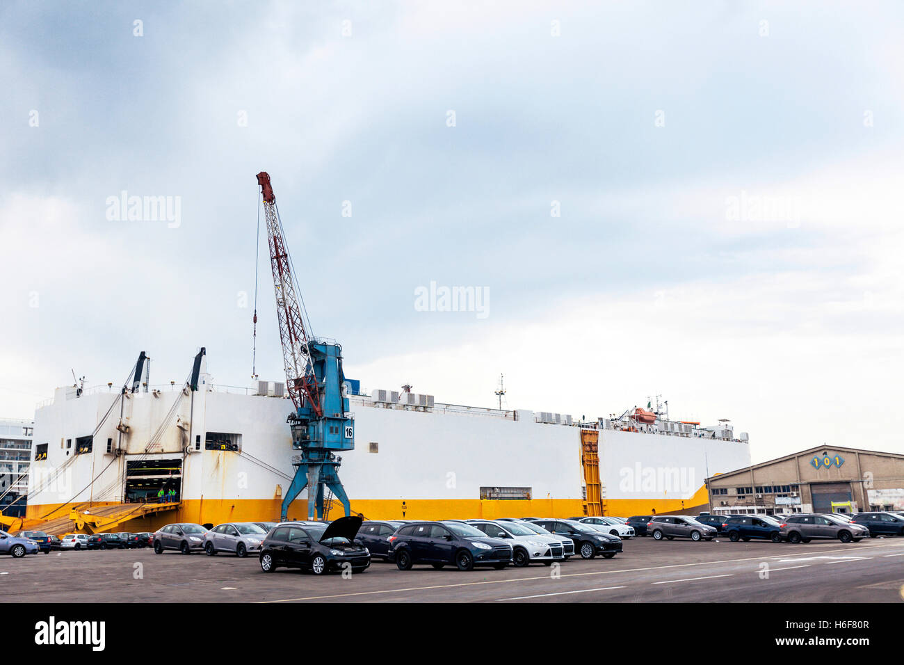 View Of A Car Freighter Docking In A Commercial Port With Cars