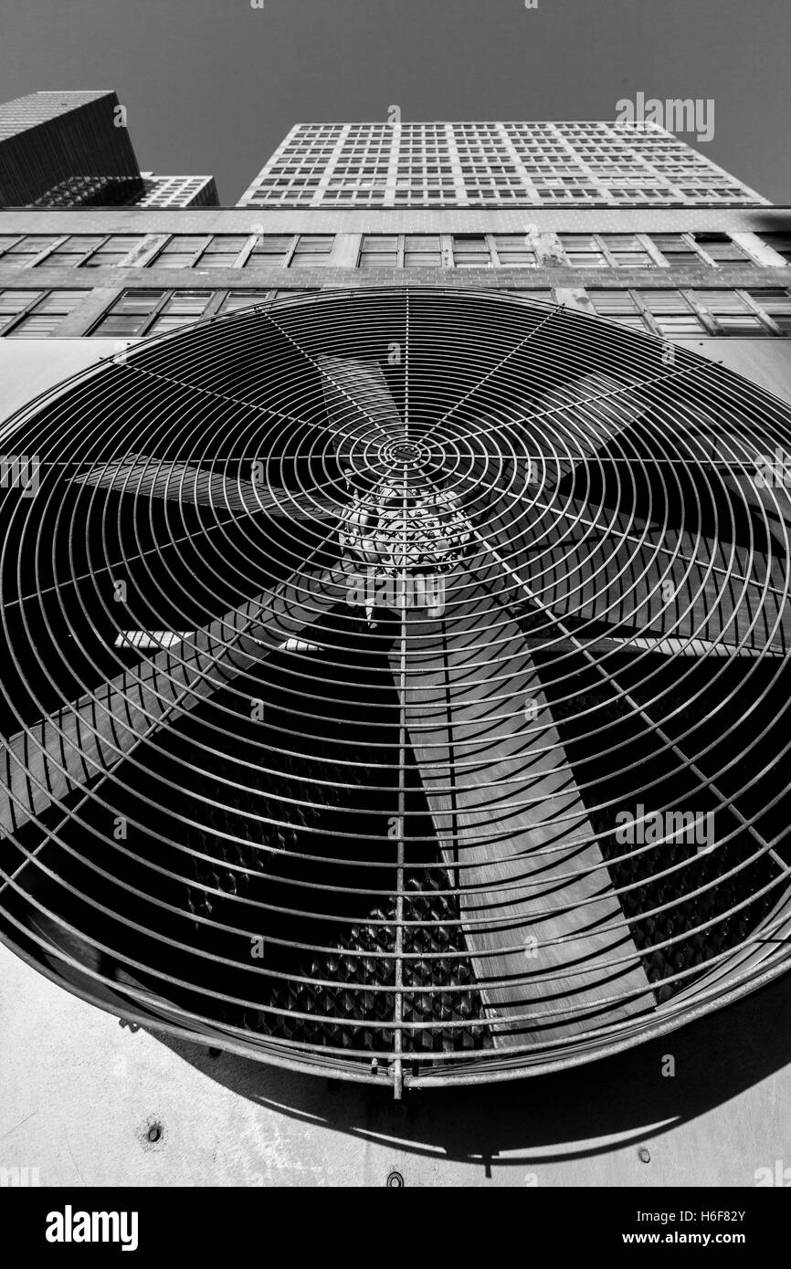 Wide angle view of an outdoor HVAC air conditioner unit located on a high-floor porch of a midtown Manhattan skyscraper. Stock Photo