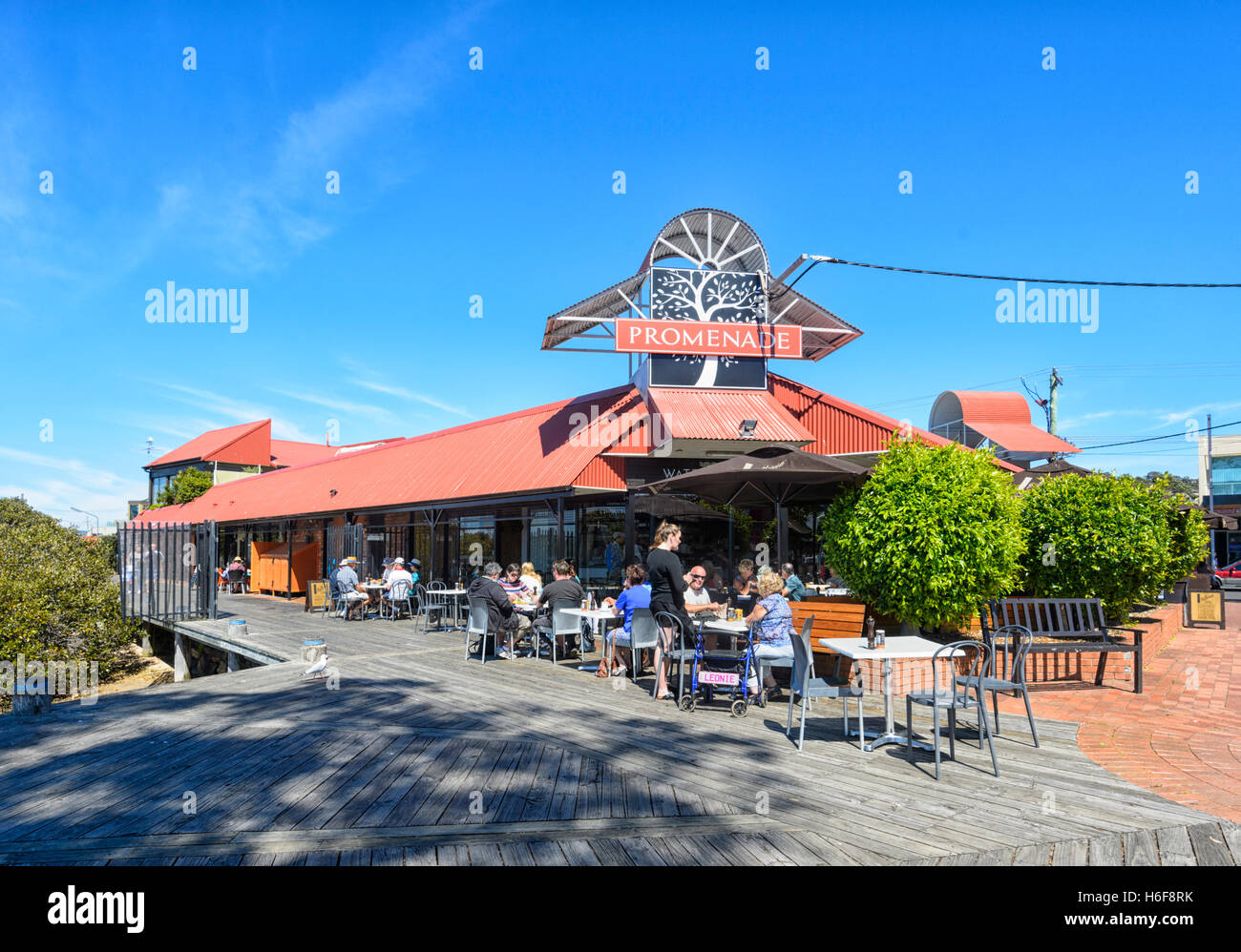People sat at the terrace of the Promenade café and restaurant, Merimbula, New South Wales, NSW, Australia Stock Photo