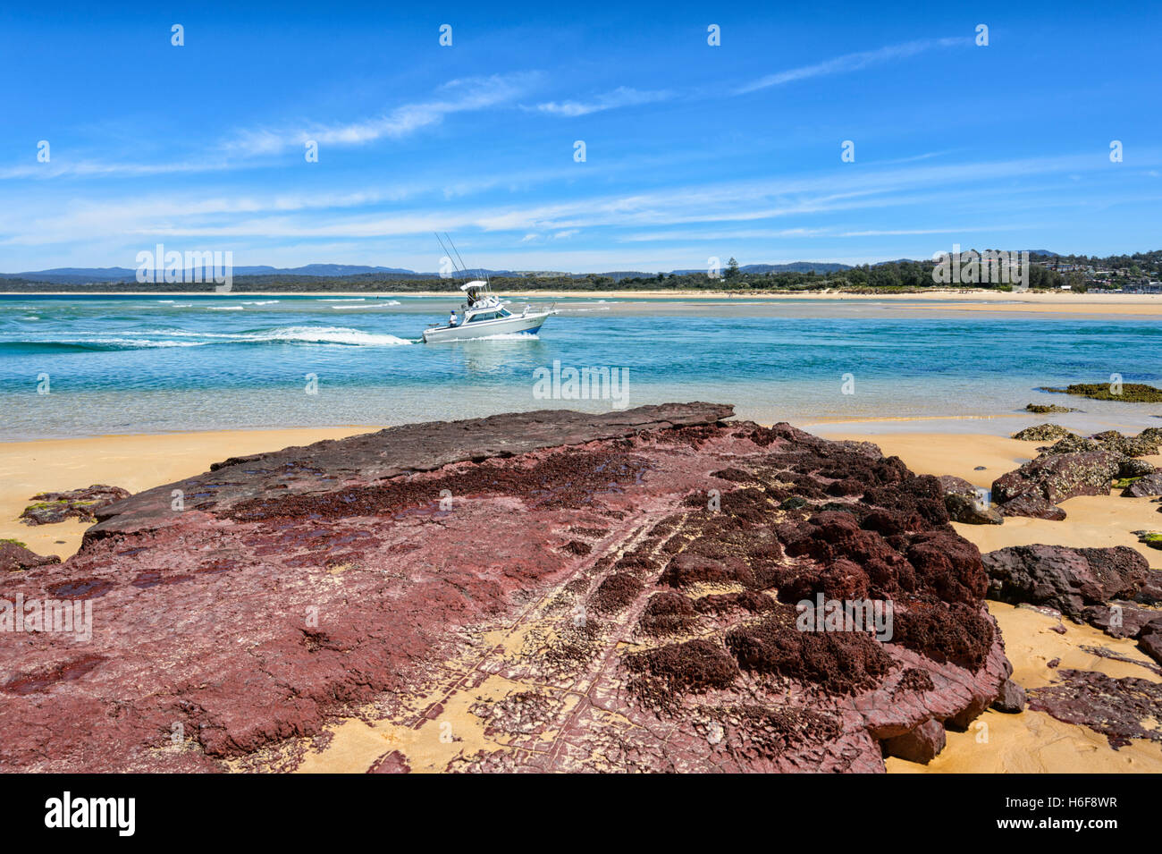 Bar Beach and its iron oxide stained rocks, Merimbula, New South Wales, NSW, Australia Stock Photo