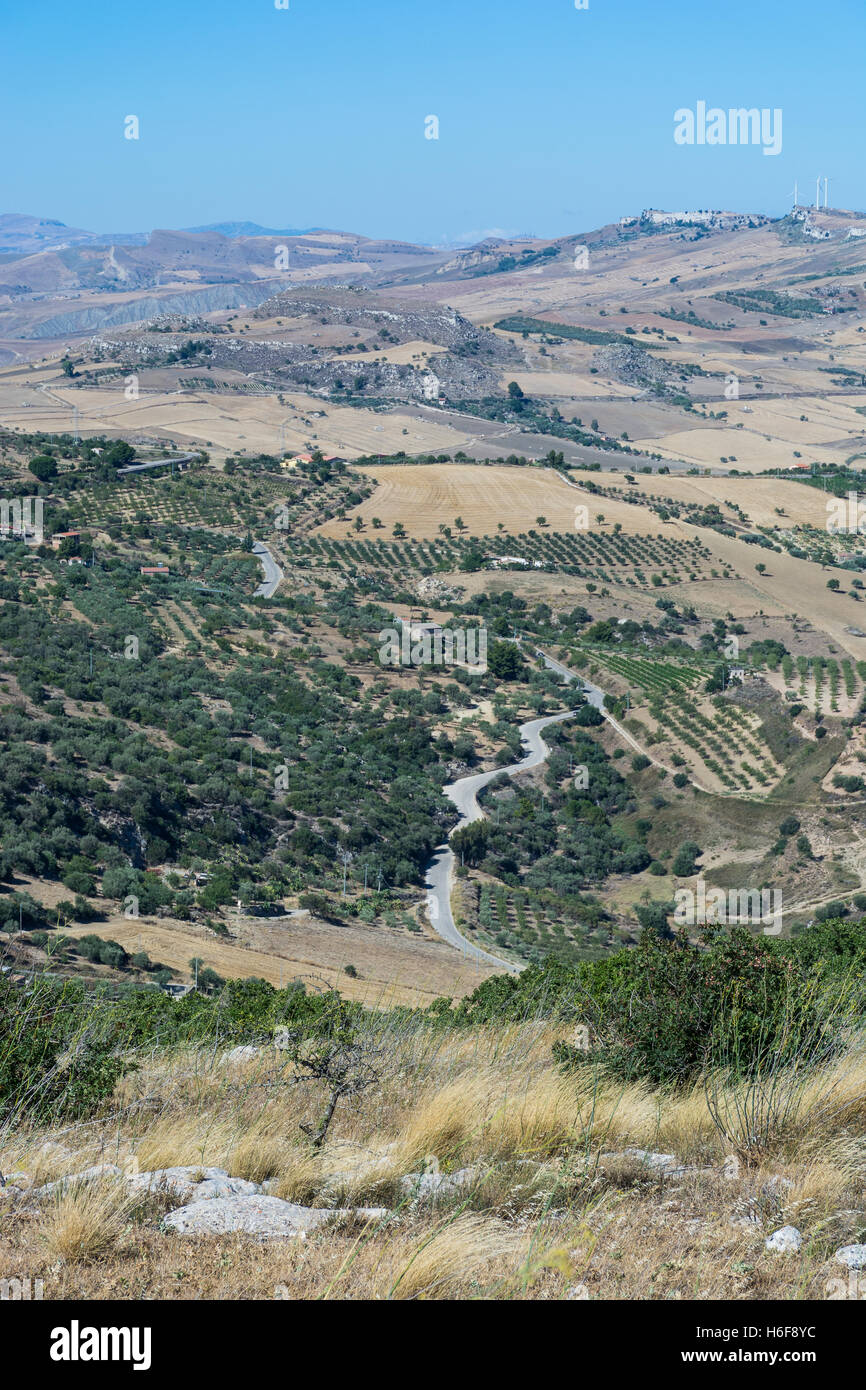 landscapes of central Sicily in summer. With the typical Sicilian hills and olive trees, with a road that winds through the moun Stock Photo