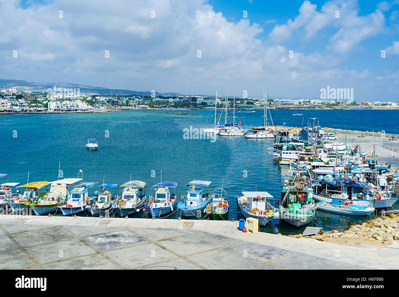 The best way to feel the atmosphere of the large coastal city is to walk among the fishing boats, moored in port, Pafos, Cyprus. Stock Photo