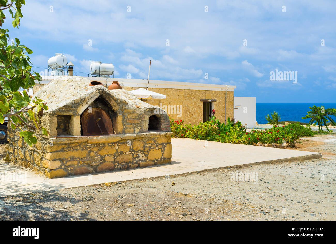 The old outdoor oven located next to the modern cottage in the coastal