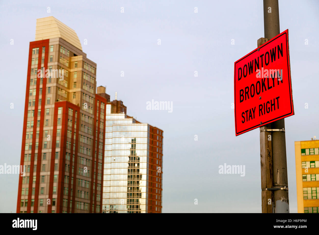 A sign on a post saying 'downtown Brooklyn stay right'. Stock Photo