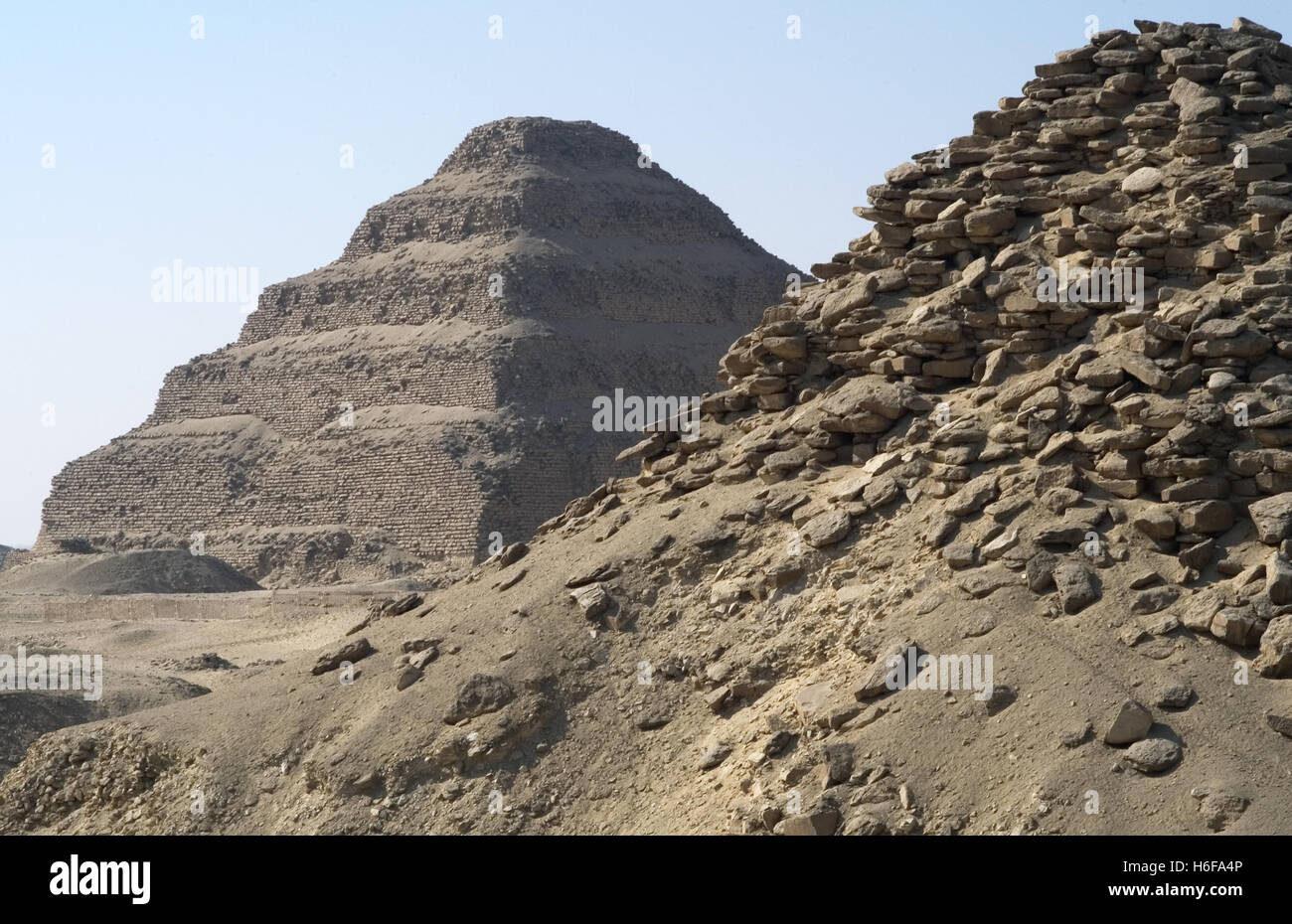 Pyramid of Userkaf. Built Ca. 2490 B.C. At background, the step Pyramid of Djoser. Old kingdom. Saqqara. Egypt. Stock Photo