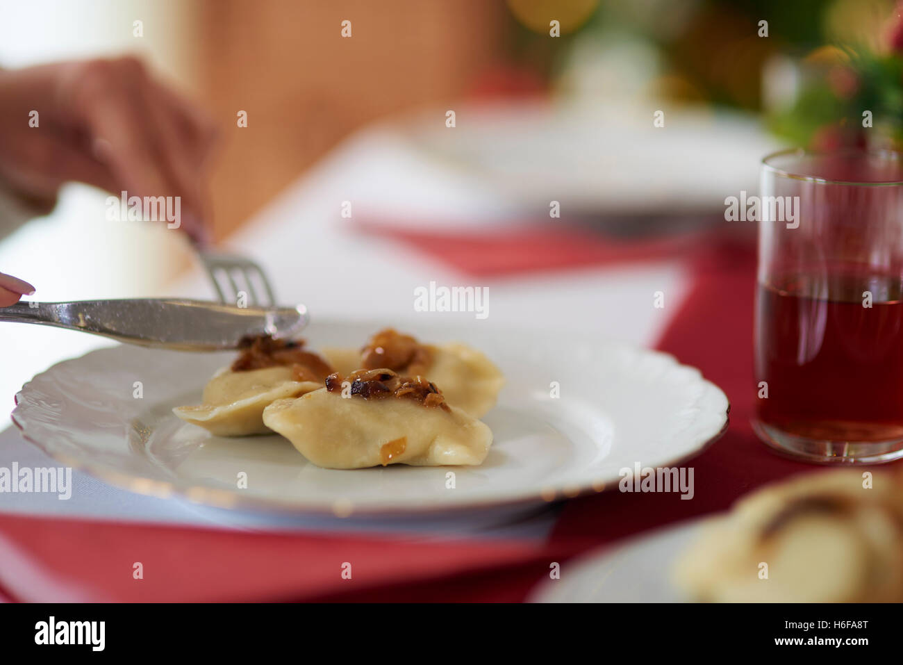 Woman eating traditional Polish dumplings Stock Photo
