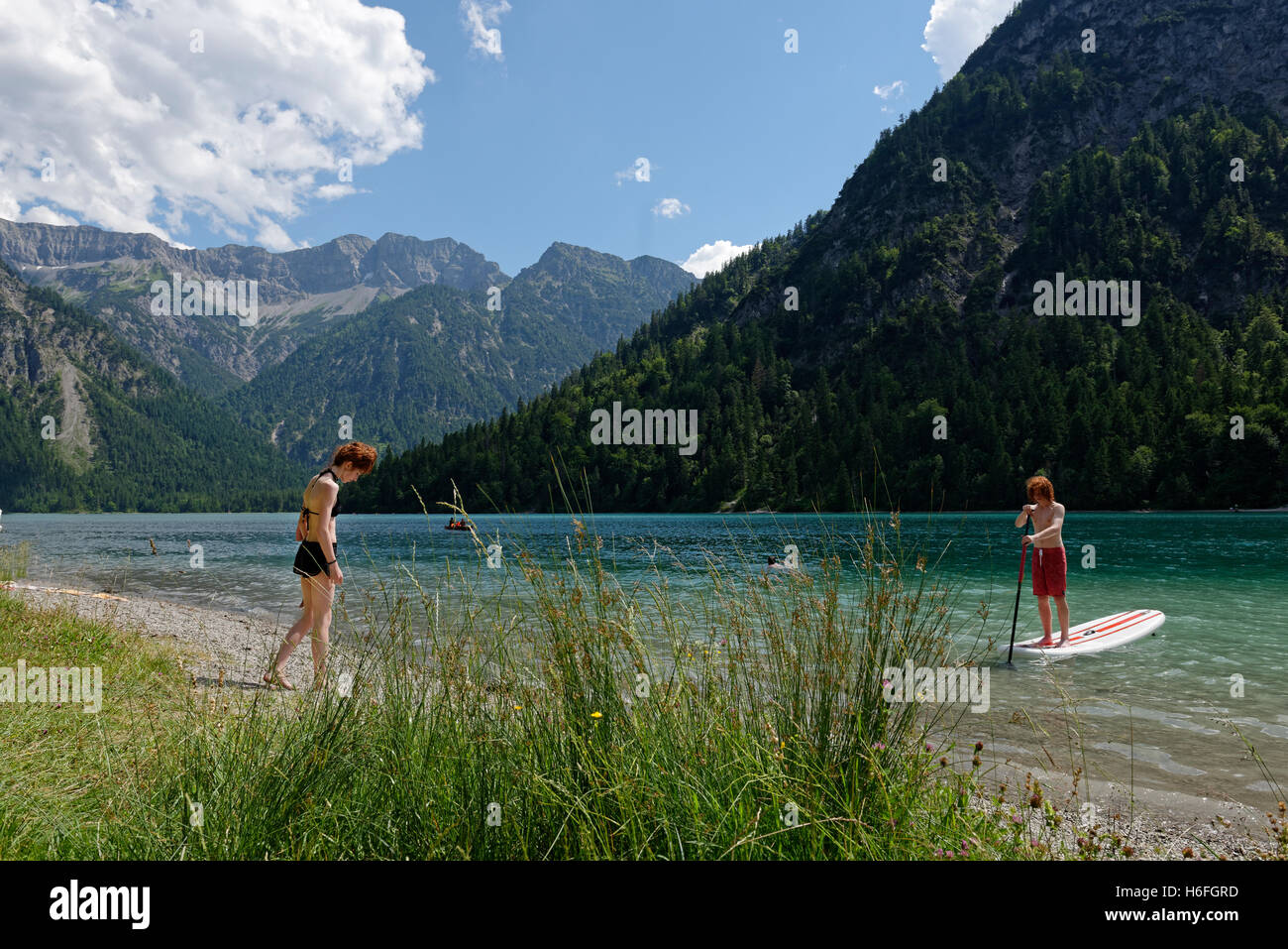 Lake Plansee, Kohlbergspitze, paddleboarding, Ammergau Alps, Tyrol, Austria Stock Photo