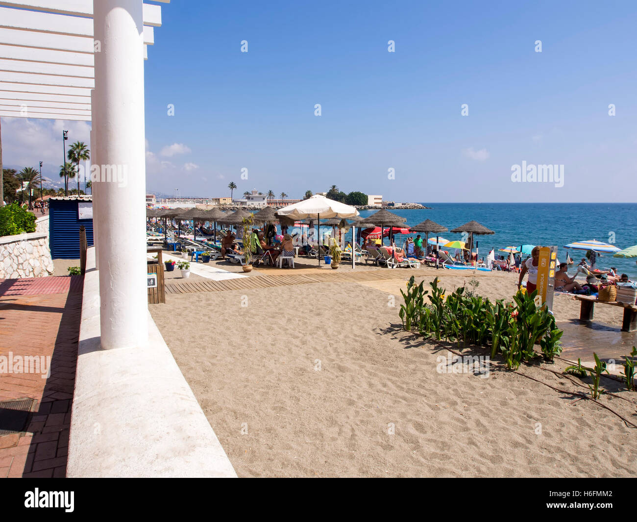 Tourists on the beach and Mediterranean Sea, Fuengirola. Costa del Sol, Malaga province. Andalusia Spain. Europe Stock Photo
