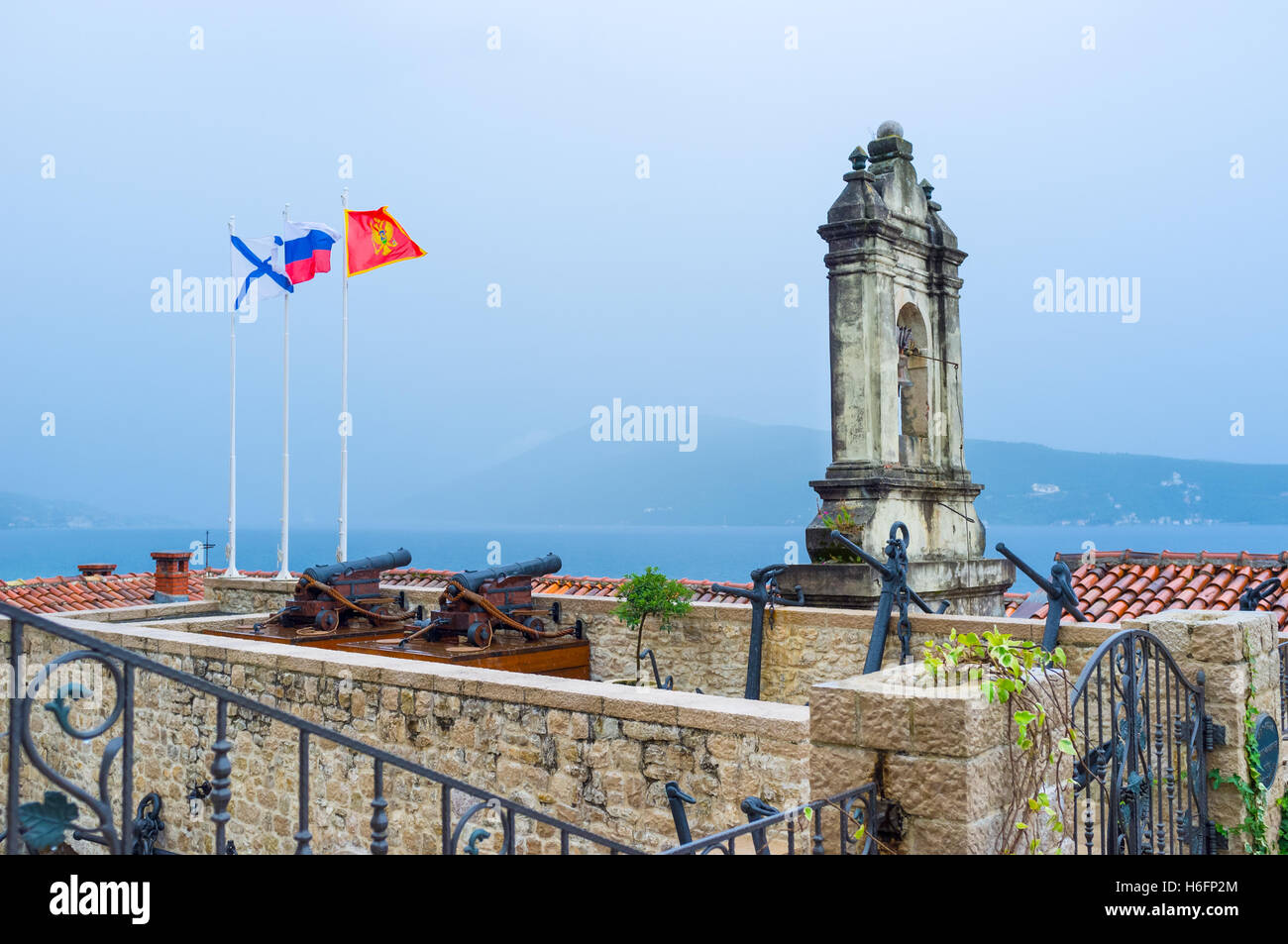 The belfry of St Spas in Topla Church with the foggy mountains on the background, Herceg Novi, Montenegro. Stock Photo