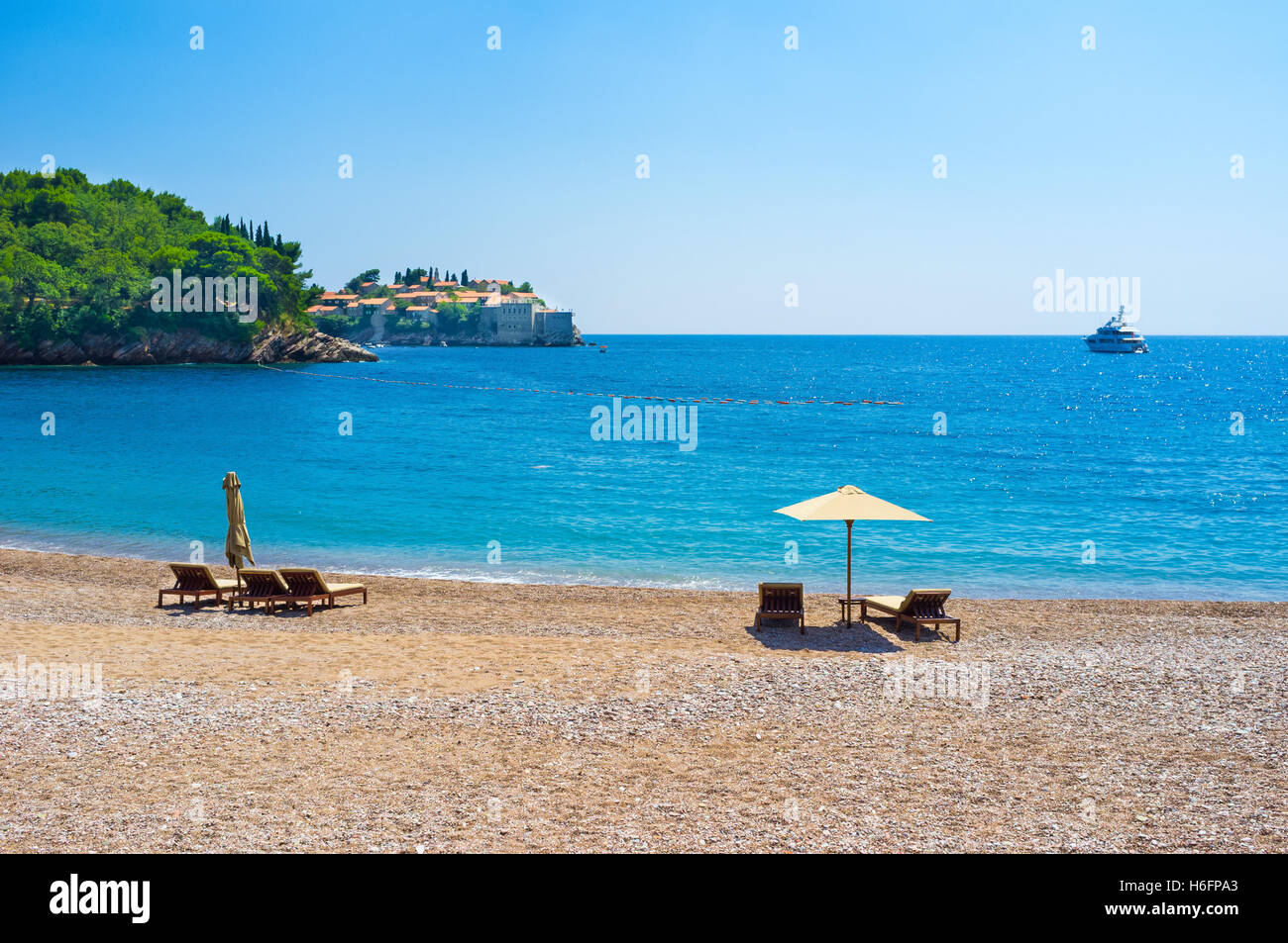 The view on the Sveti Stefan islet from the Queens beach of the Villa Milocer, Montenegro. Stock Photo