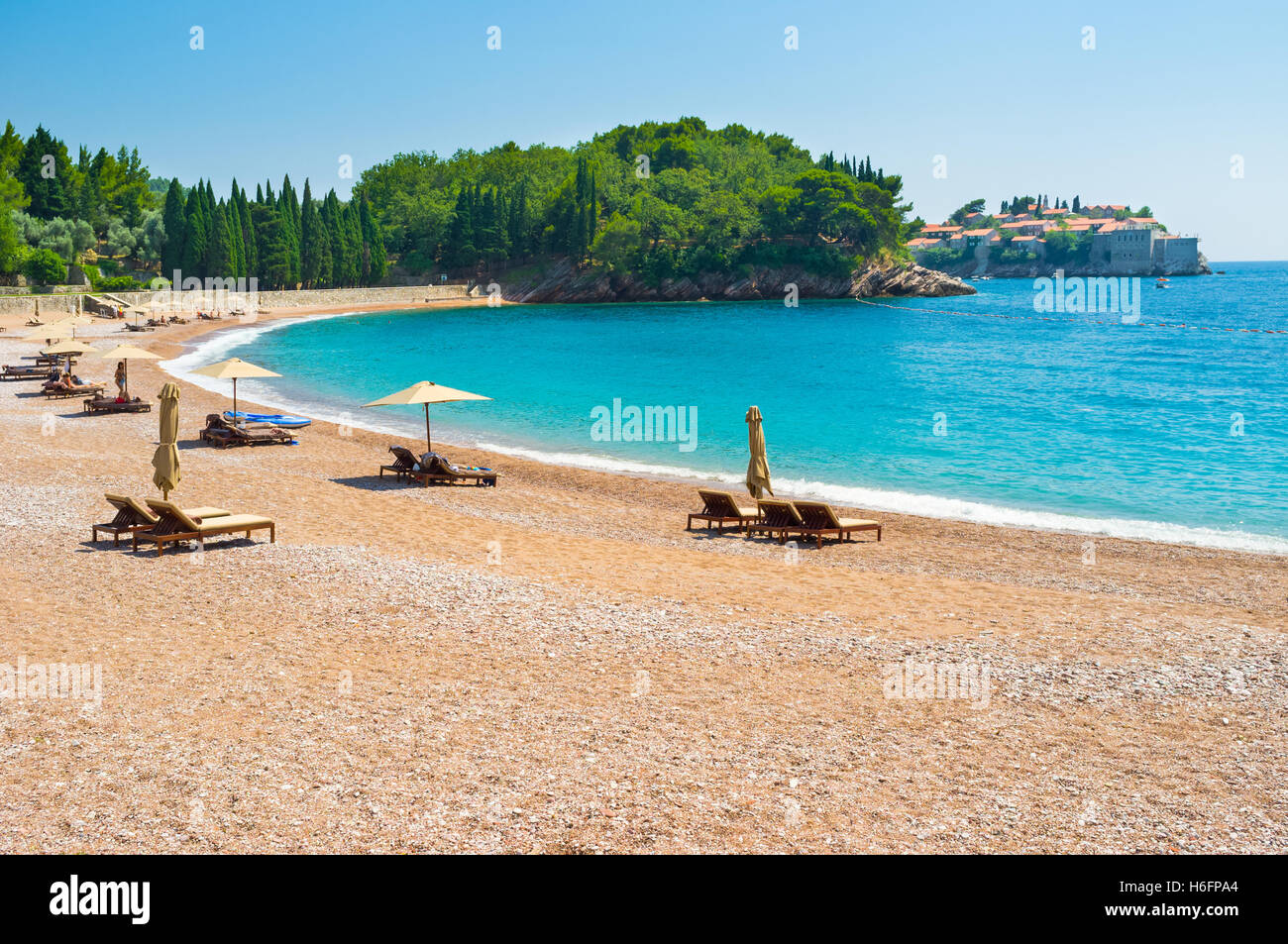 The Queens beach boasts the soft sand calm sea and the perfect view on the Sveti Stefan islet, Montenegro. Stock Photo