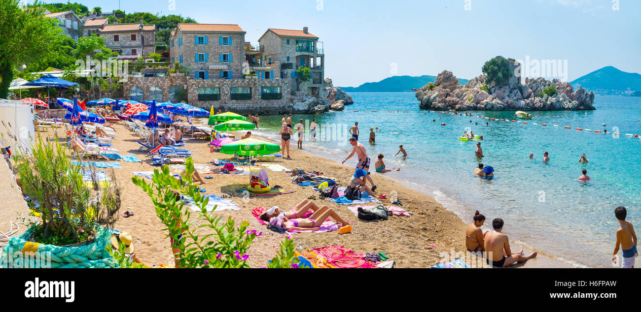 The old fishing village nowadays became the popular tourist place with the sand beach, numerous cafes, Sveti Stefan Montenegro Stock Photo